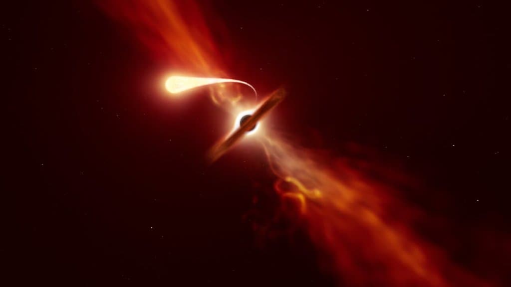 Artist's impression of a star drawn out into a long glowing stream of gas as it is torn apart by a supermassive black hole, with a bright disc and outflows around the black hole.