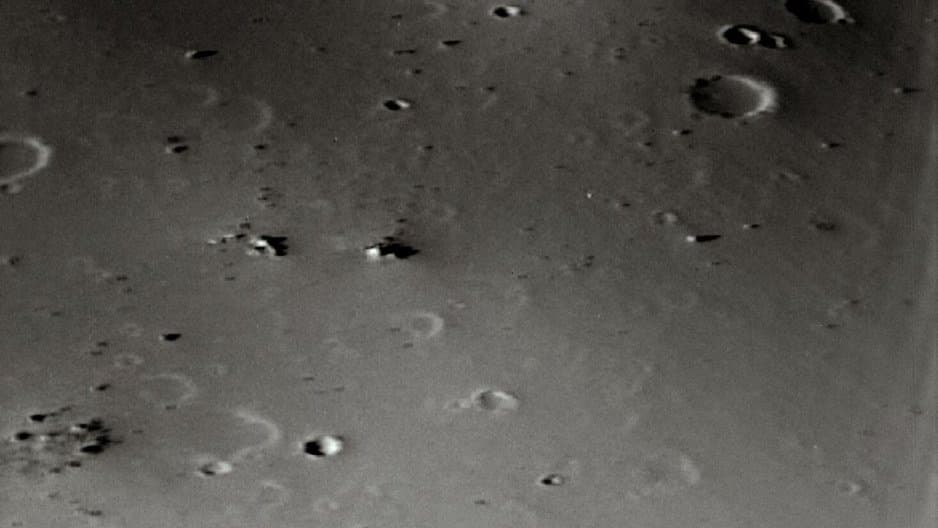 The small, smooth, crater-dotted surface of Deimos photographed close up by the Viking 1 orbiter