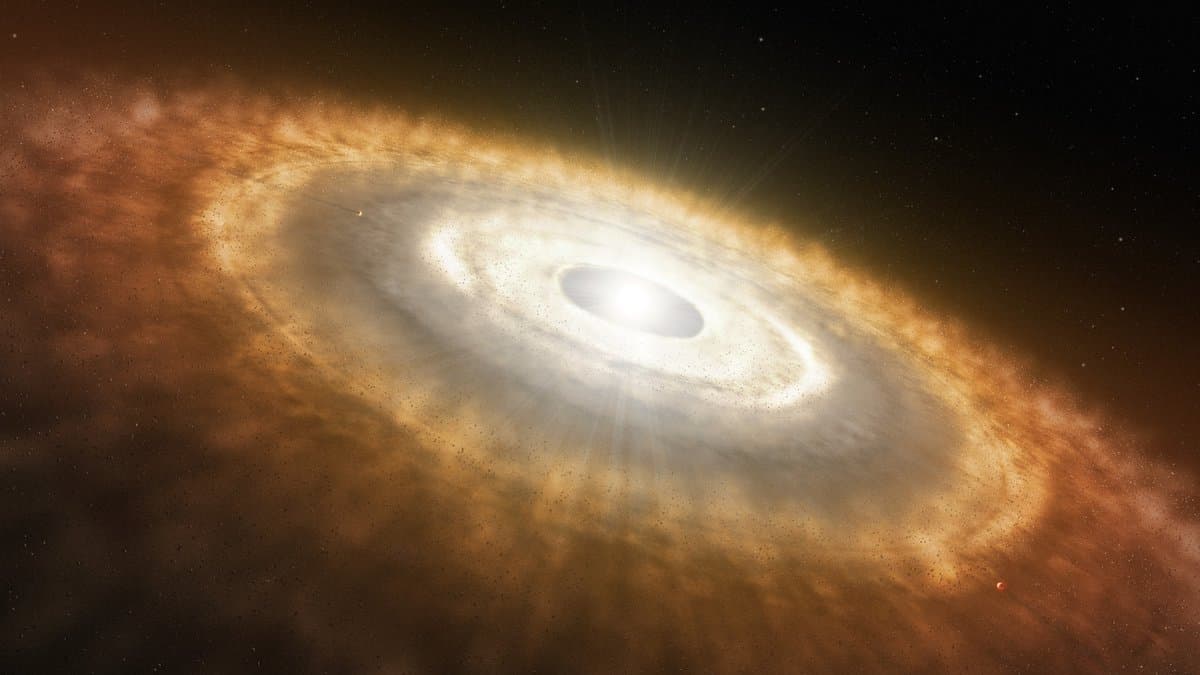 Artist's impression of a young star surrounded by a thick, glowing disk of gas and dust seen almost edge on against a starfield.