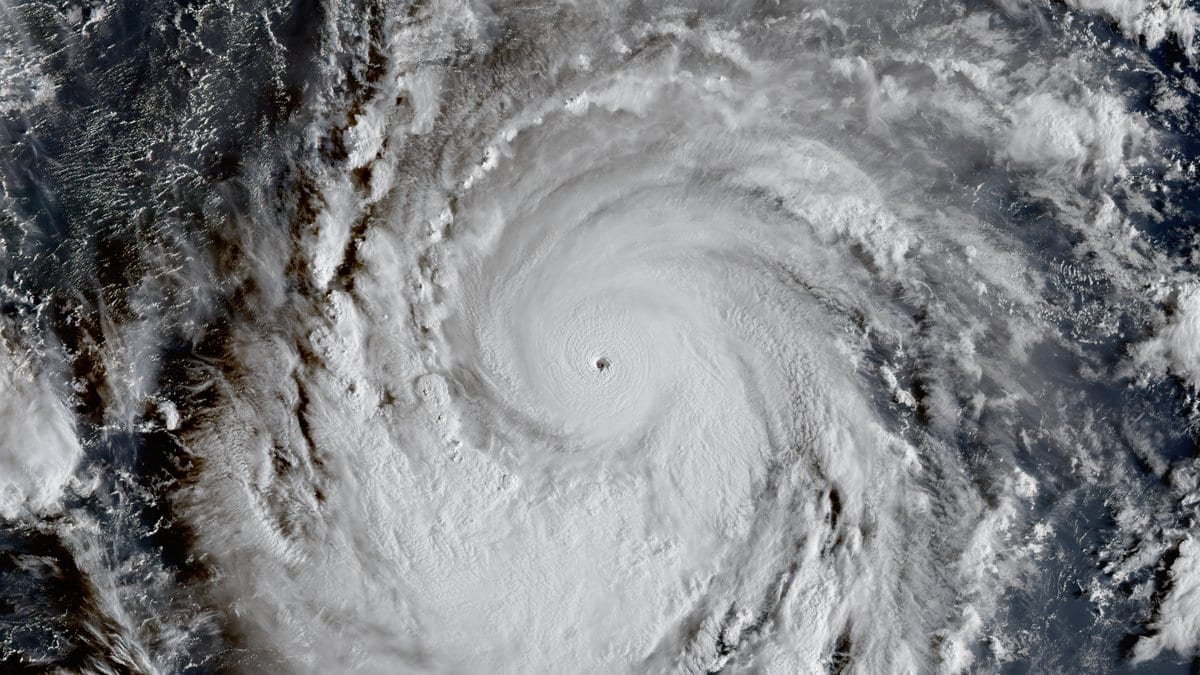 A satellite view of Typhoon Champi's dense spiral cloud band and distinct eye over the open Pacific